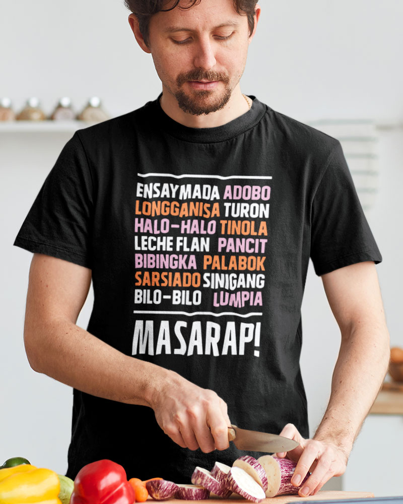 Man chopping vegetables, wearing t-shirt